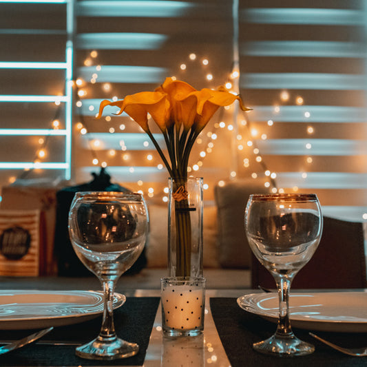 orange flowers and sparkling place settings for a dinner date night